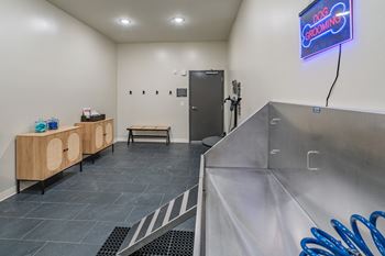 a spa room with a shower and wooden furniture and a stainless steel tub